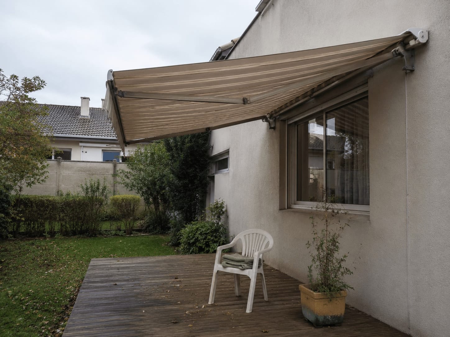 Toldo retrátil estendido sobre deck de madeira em residência em Curitiba